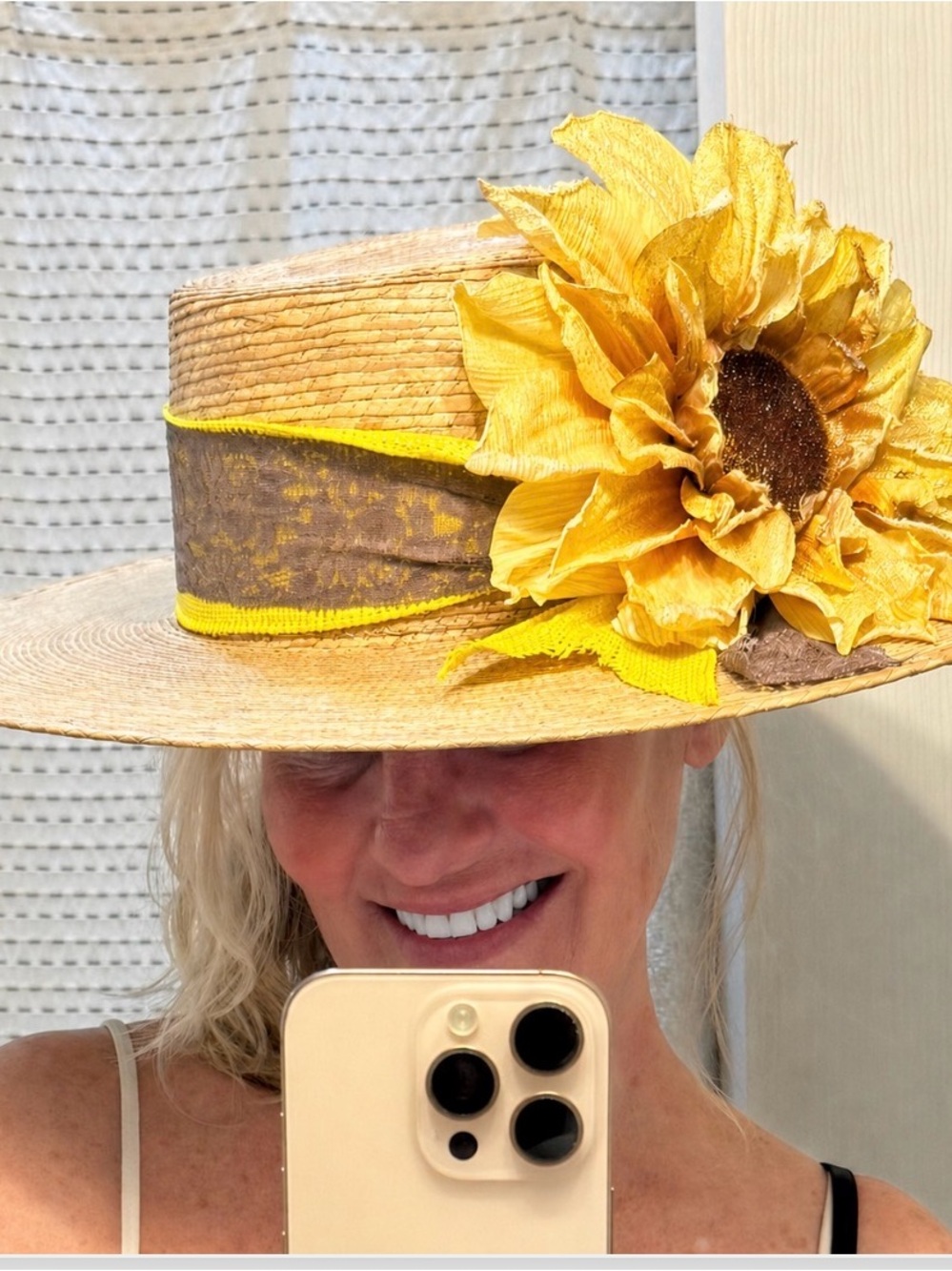 Boater hat with wide brim, palm material, and large sunflower with shimmer